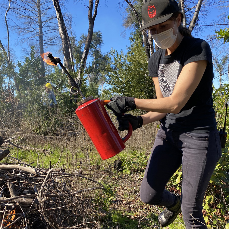 kristina-lighting-fire-to-burn-pile